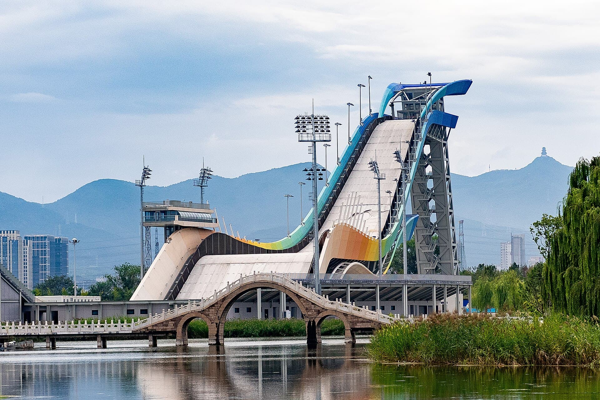 Big Air Shougang gives Beijing a rare mix of Olympic legacy, industrial architecture, and mountain-backed drama.