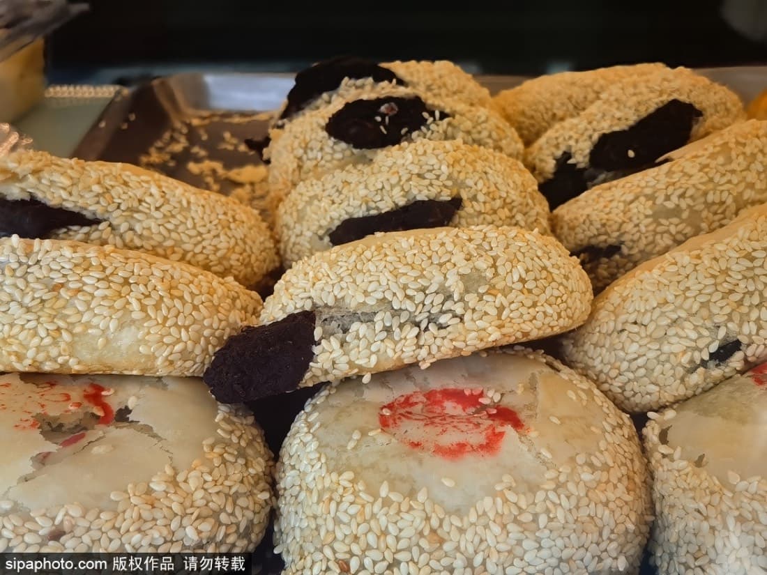 Huguosi-style snack counters make old Beijing easier to sample because you can mix sweet, savory, mild, and challenging bites.
