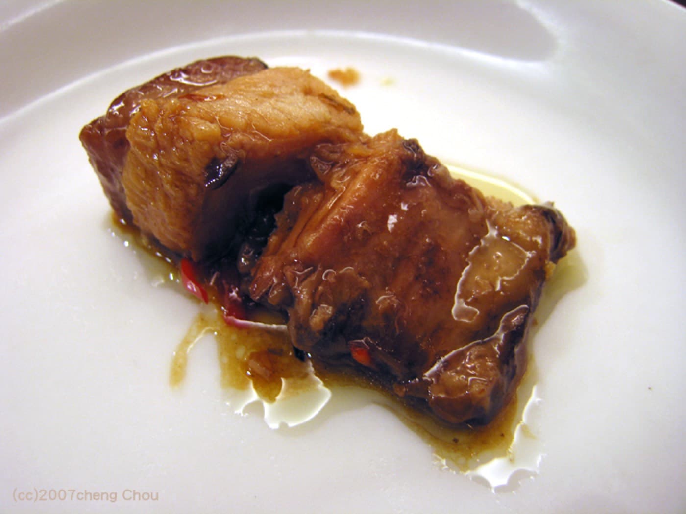 The best versions balance skin, fat, lean meat, wine aroma, sweetness, and a sauce that asks for rice.