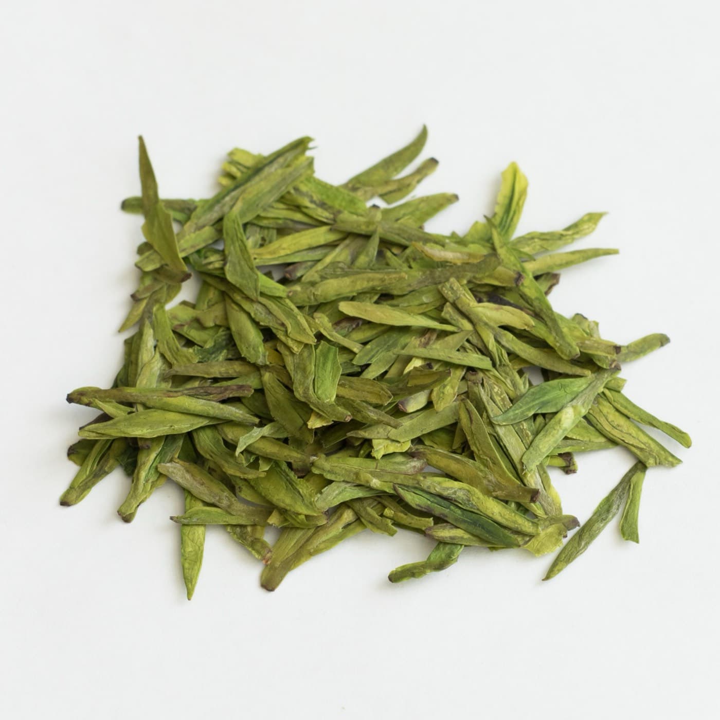 Good Longjing leaves are often judged by shape, color, aroma, picking time, and how they open in hot water.