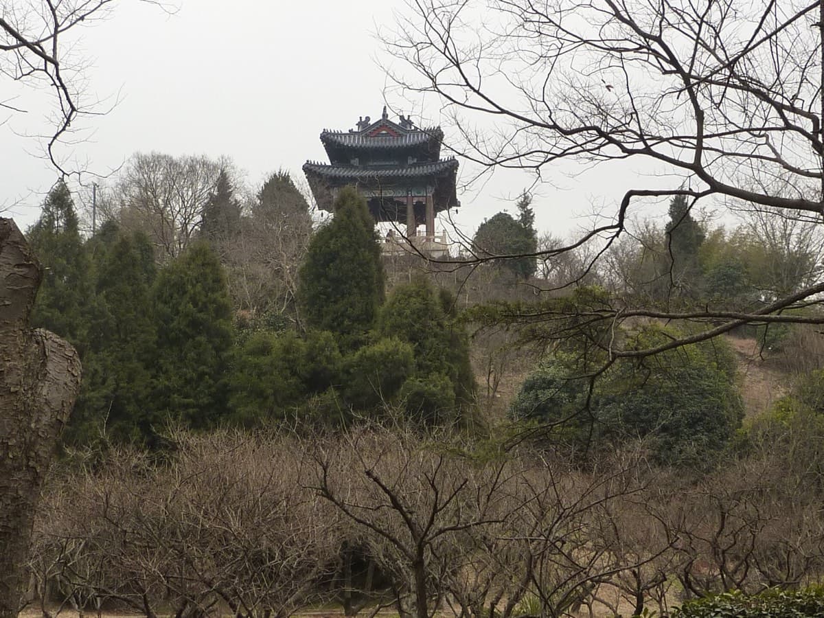 Ming Xiaoling works because the mausoleum, forest, and mountain setting belong together.