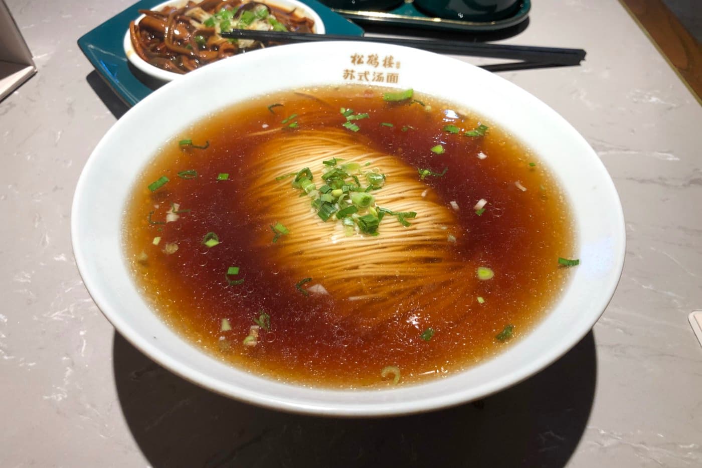 A bowl of noodles with toppings is one of the clearest windows into everyday Suzhou.
