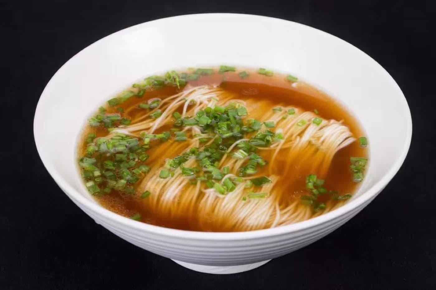 Red soup noodles are soy-colored, clean, and more aromatic than heavy.