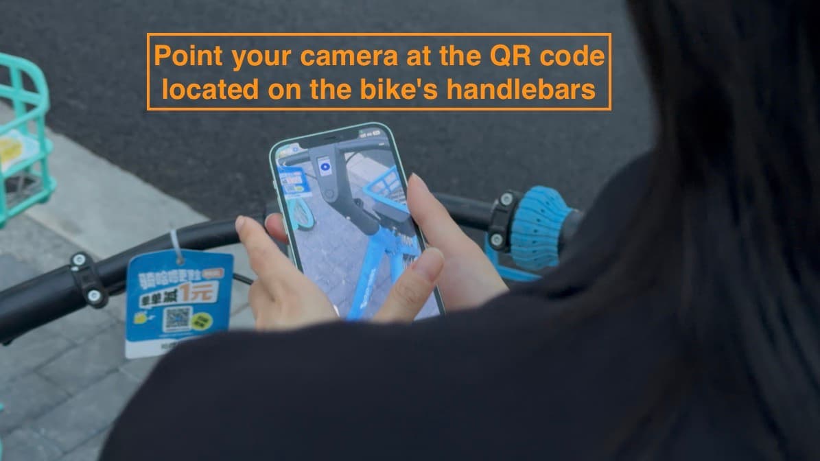 Scanning the QR code on a shared bike handlebar with Alipay