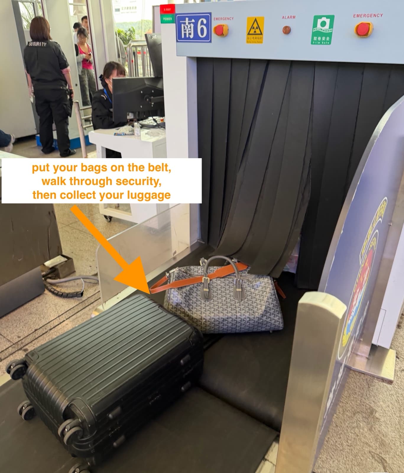 Station security X-ray scanner with luggage being placed on the belt
