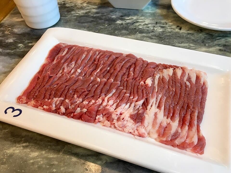 Hand-cut lamb is one of the clearest quality signals at an old Beijing hotpot table.