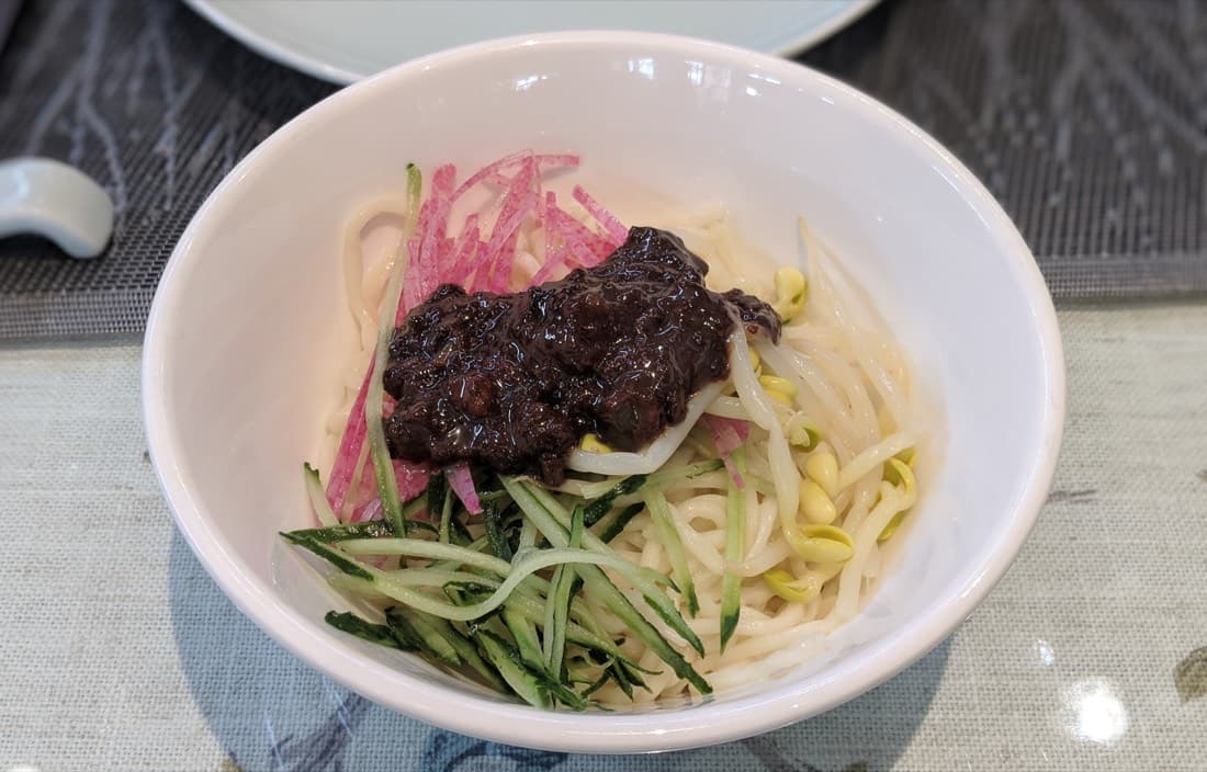 The vegetables are not decoration. They cut through the sauce and keep the bowl lively.
