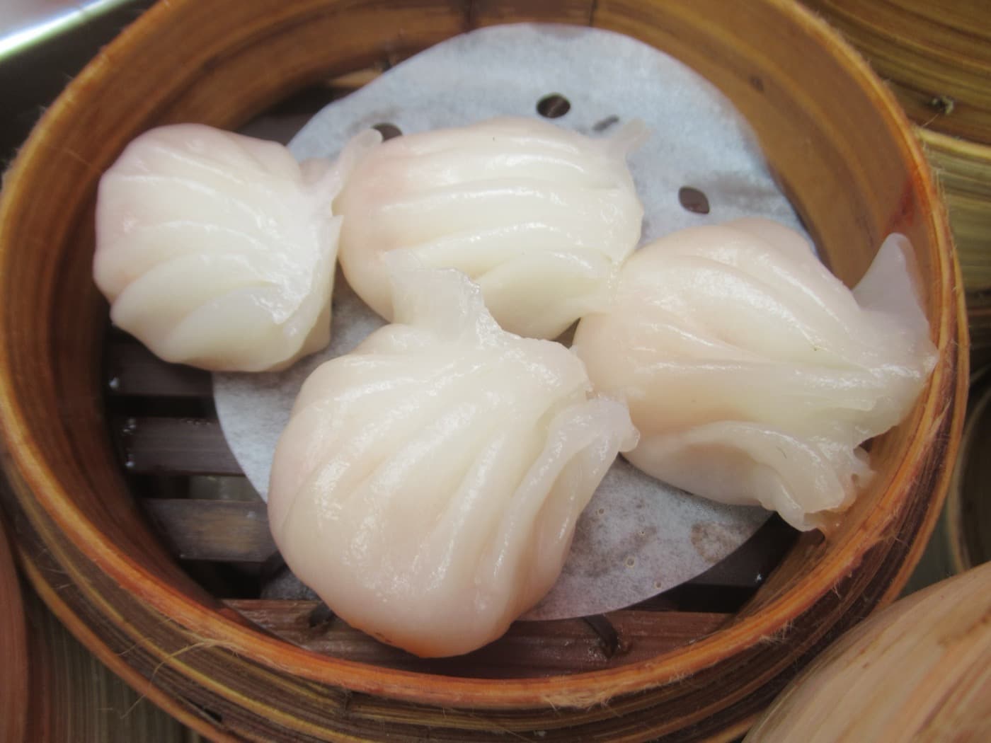 Har gow is the gentle gateway dish: translucent wrapper, shrimp filling, and very little cultural homework.