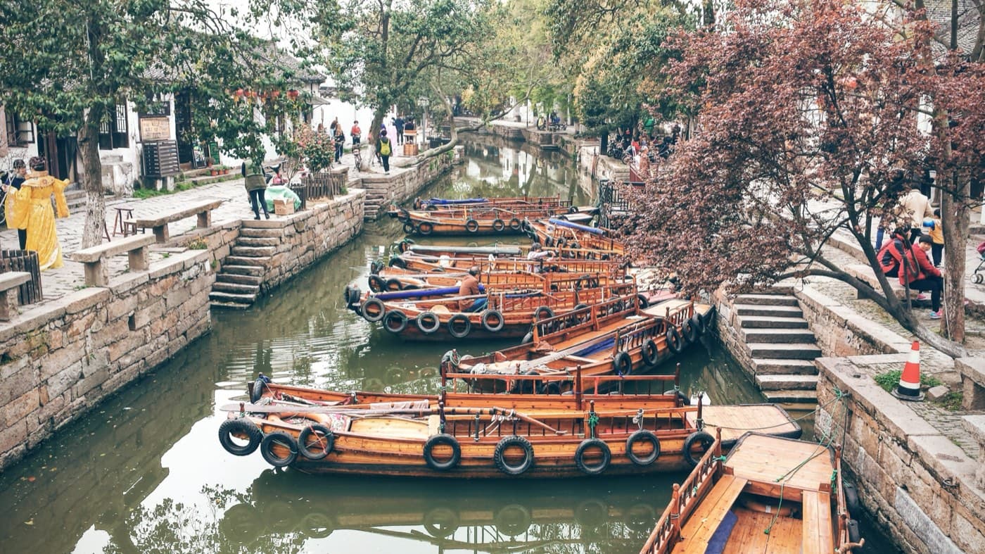 In summer, water-town scenery is still beautiful, but timing matters more.